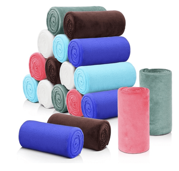 A pile of rolled up towels in various colors.